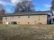 Rear view of brick house with AC unit and yard at 2883 Westfield Nw Ave, Concord, NC 28027