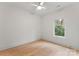 Simple bedroom with hardwood floors and large window at 2911 Hilliard Dr, Charlotte, NC 28205