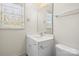 Simple bathroom with white vanity and toilet at 3003 Springs Farm Ln, Charlotte, NC 28226