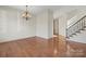 Hardwood floor dining room with chandelier and view of staircase at 3003 Springs Farm Ln, Charlotte, NC 28226