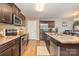 Kitchen with dark brown cabinets, granite countertops, and island at 4024 Long Arrow Dr, Concord, NC 28025