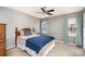 Bright bedroom with a double bed, ceiling fan, and ample natural light at 618 White Oak Ln, Matthews, NC 28104