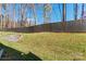 Landscaped backyard with privacy fence and stone retaining wall at 9232 Widden Way, Charlotte, NC 28269