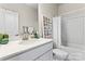 Clean bathroom with white vanity, bathtub, and picture frame decor at 9232 Widden Way, Charlotte, NC 28269