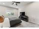 Bright bedroom with a queen bed, TV, and window overlooking a garden at 9232 Widden Way, Charlotte, NC 28269