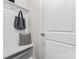 White bench with storage and hooks in entryway at 9232 Widden Way, Charlotte, NC 28269