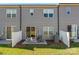 Rear view of townhouses with gray siding and fenced yards at 9232 Widden Way, Charlotte, NC 28269