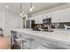 Bright kitchen with white cabinets, quartz countertops, and stainless steel appliances at 9232 Widden Way, Charlotte, NC 28269