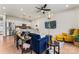 Open living room featuring a blue sofa, yellow armchair, and a view into the kitchen at 9232 Widden Way, Charlotte, NC 28269