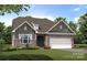 Craftsman style home with gray siding, stone accents, and a two-car garage at 112 N Dunlavin Way # 1, Mooresville, NC 28115