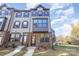 Brick front exterior of a three-story townhome with landscaping and walkway at 144 Millsbee Ln, Charlotte, NC 28205