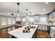 Open concept kitchen features an island and stainless steel appliances at 1612 Lasalle St, Charlotte, NC 28216