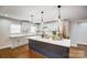 Modern kitchen with white cabinets, large island, and stainless steel appliances at 1612 Lasalle St, Charlotte, NC 28216