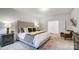 Serene bedroom with upholstered bed and plenty of natural light at 2015 Cedar Falls Dr # 72, Waxhaw, NC 28173