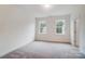 Bright bedroom with neutral carpet and two windows at 2015 Cedar Falls Dr # 72, Waxhaw, NC 28173