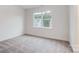 Bright bedroom featuring a large window and neutral carpet at 2015 Cedar Falls Dr # 72, Waxhaw, NC 28173