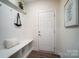 White drop zone with bench, shelf, and hooks, providing convenient storage at 2015 Cedar Falls Dr # 72, Waxhaw, NC 28173