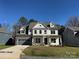 Two story home with gray siding, stone accents, and a 2-car garage at 2015 Cedar Falls Dr # 72, Waxhaw, NC 28173