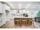 Modern kitchen with white cabinets, island with seating, and dining area at 2015 Cedar Falls Dr # 72, Waxhaw, NC 28173