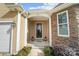 Inviting entryway with stone accents, a stylish door, and lanterns at 226 Hermance Ln, Mooresville, NC 28117