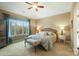 Main bedroom with a king-size bed and large windows with wooded views at 226 Hermance Ln, Mooresville, NC 28117