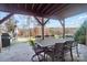 Covered patio with lake view, outdoor dining set, and grill at 226 Hermance Ln, Mooresville, NC 28117