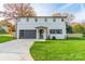 Modern white house with a gray garage door and well-maintained lawn at 628 Kenlough Dr, Charlotte, NC 28209