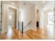 Light-filled hallway with hardwood floors and access to multiple rooms at 628 Kenlough Dr, Charlotte, NC 28209