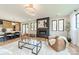 Open living room with fireplace, large windows, and stylish furniture at 628 Kenlough Dr, Charlotte, NC 28209