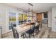 Bright dining room with white farmhouse table and access to the backyard pool at 6980 Mooresville Rd, Kannapolis, NC 28081