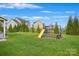 Grass backyard with a playground set and a large grassy area at 10418 Sable Cap Rd, Mint Hill, NC 28227