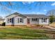 Ranch style home with gray siding, red door and landscaped lawn at 107 Dawn Dr, Mount Holly, NC 28120