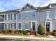 Gray townhome exterior with dark shutters, brick walkway, and landscaping at 110 Mint Ave # C, Mooresville, NC 28117