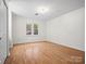 Bright bedroom with hardwood floors, window, and chandelier at 124 Ashleigh Ct, Fort Mill, SC 29715