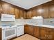 Bright kitchen features wood cabinets, white appliances, and a double sink at 124 Ashleigh Ct, Fort Mill, SC 29715