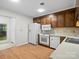 Kitchen with wood cabinets, white appliances and wood floors at 124 Ashleigh Ct, Fort Mill, SC 29715