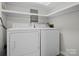 Laundry area with washer, dryer, and overhead shelving at 124 Ashleigh Ct, Fort Mill, SC 29715