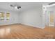 Living room with hardwood floors, ceiling fan and bathroom access at 124 Ashleigh Ct, Fort Mill, SC 29715