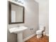 Small bathroom with pedestal sink, toilet, and mirror at 12816 Cumberland Cove Dr, Charlotte, NC 28273