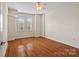 Hardwood floor bedroom with neutral walls and ceiling fan at 1315 East Blvd # 515, Charlotte, NC 28203