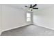 Well-lit bedroom featuring a ceiling fan and plush carpeting at 3012 Isle Ln, Monroe, NC 28110