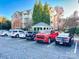 Exterior view of condo building with parking lot and cars at 3248 Margellina Dr, Charlotte, NC 28210