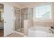 Bathroom with soaking tub, shower, and tile surround at 5020 Star Hill Ln, Charlotte, NC 28214