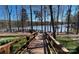 Wooden boardwalk leads to lake with scenic views and picnic tables at 5020 Star Hill Ln, Charlotte, NC 28214