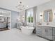 Elegant bathroom with double vanity, free-standing tub and walk-in closet at Lot 47 Watercourse Way # Devonshire, Belmont, NC 28012