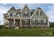 Two-story house with stone accents and a two-car garage at Lot 47 Watercourse Way # Devonshire, Belmont, NC 28012