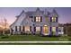 Two-story house with stone accents and a three-car garage at Lot 47 Watercourse Way # Devonshire, Belmont, NC 28012