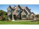 Two-story house with stone accents and a two-car garage at Lot 41 Rivermist Dr # Devonshire, Belmont, NC 28012