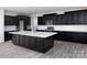 Kitchen with dark cabinetry, large island, and quartz countertops at Lot 47 Watercourse Way # Devonshire, Belmont, NC 28012