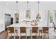 Bright kitchen with white cabinets, large island, and gold light fixtures at Lot 47 Watercourse Way # Devonshire, Belmont, NC 28012